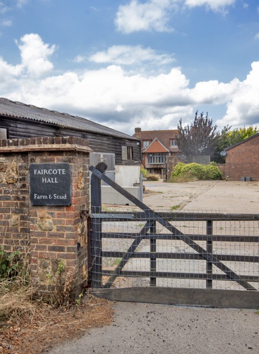 The Faircote Hall Farm and Stud sign on the brick gate pillar